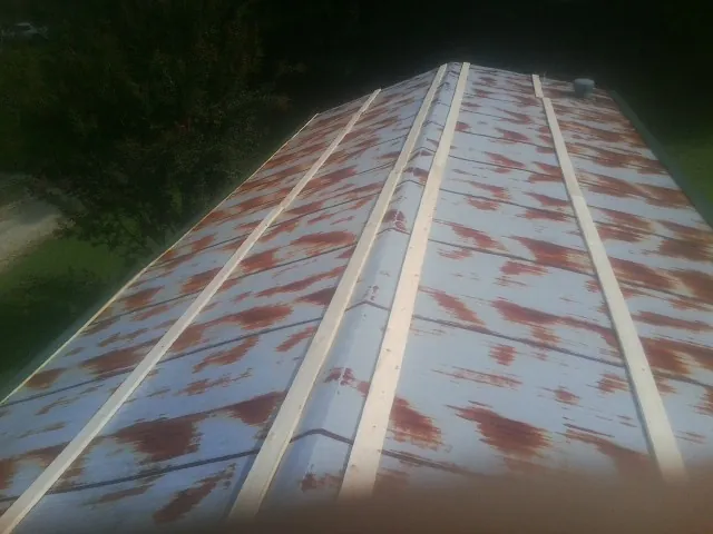 Rusted metal roof panels with new wood purlins before replacement — Storm Damage Roof Repair in Port William by Roofing Brothers